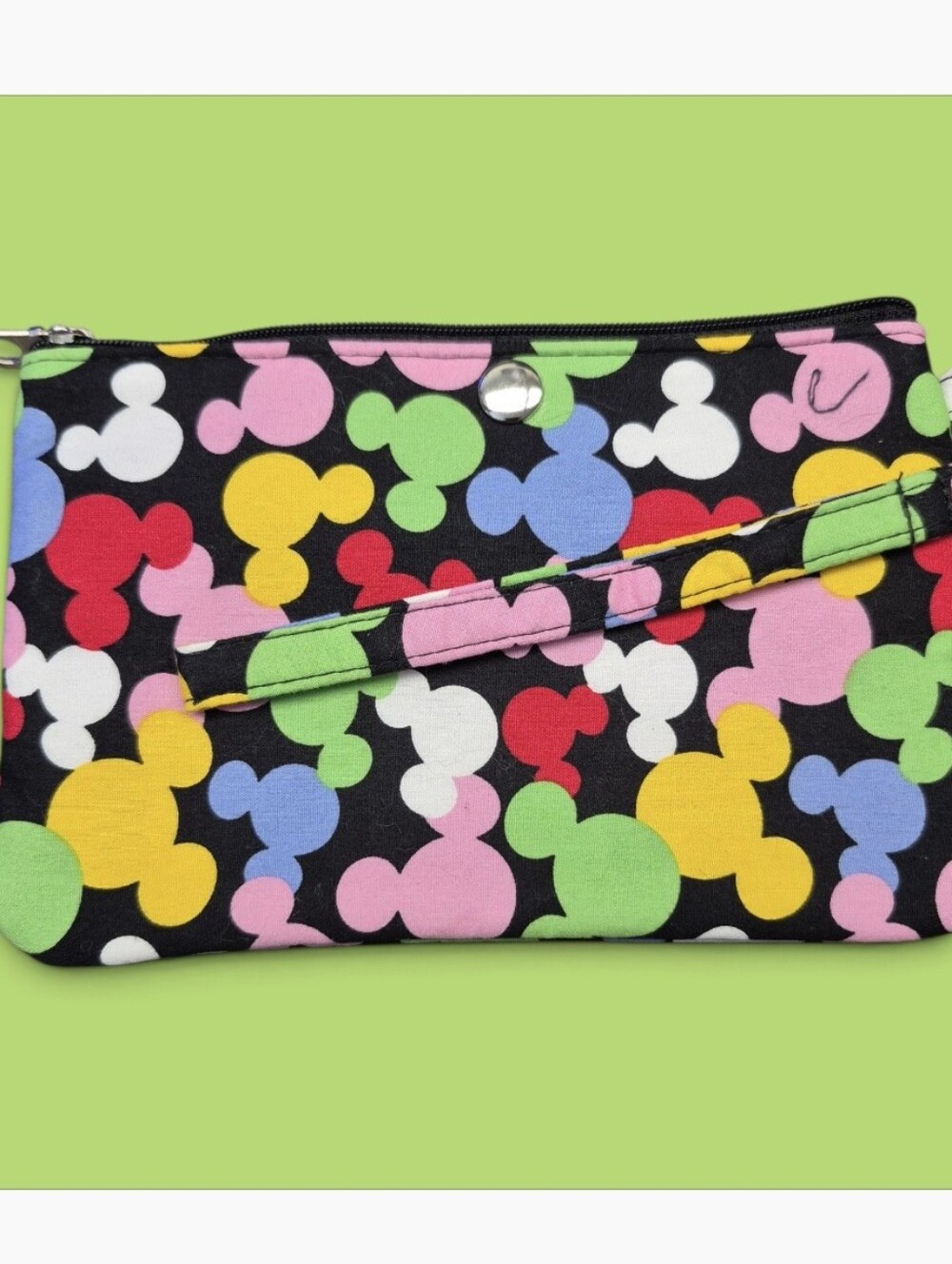Disney Parks-inspired zippered wristlet pouch vibrant all-over multicolor print